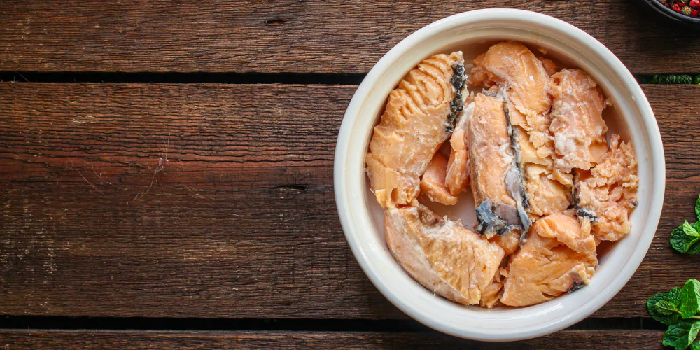 A picture of canned salmon in a ceramic bowl