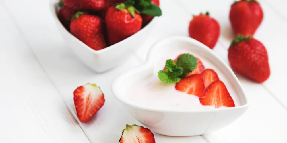 A picture of strawberries and yoghurt in a bowl